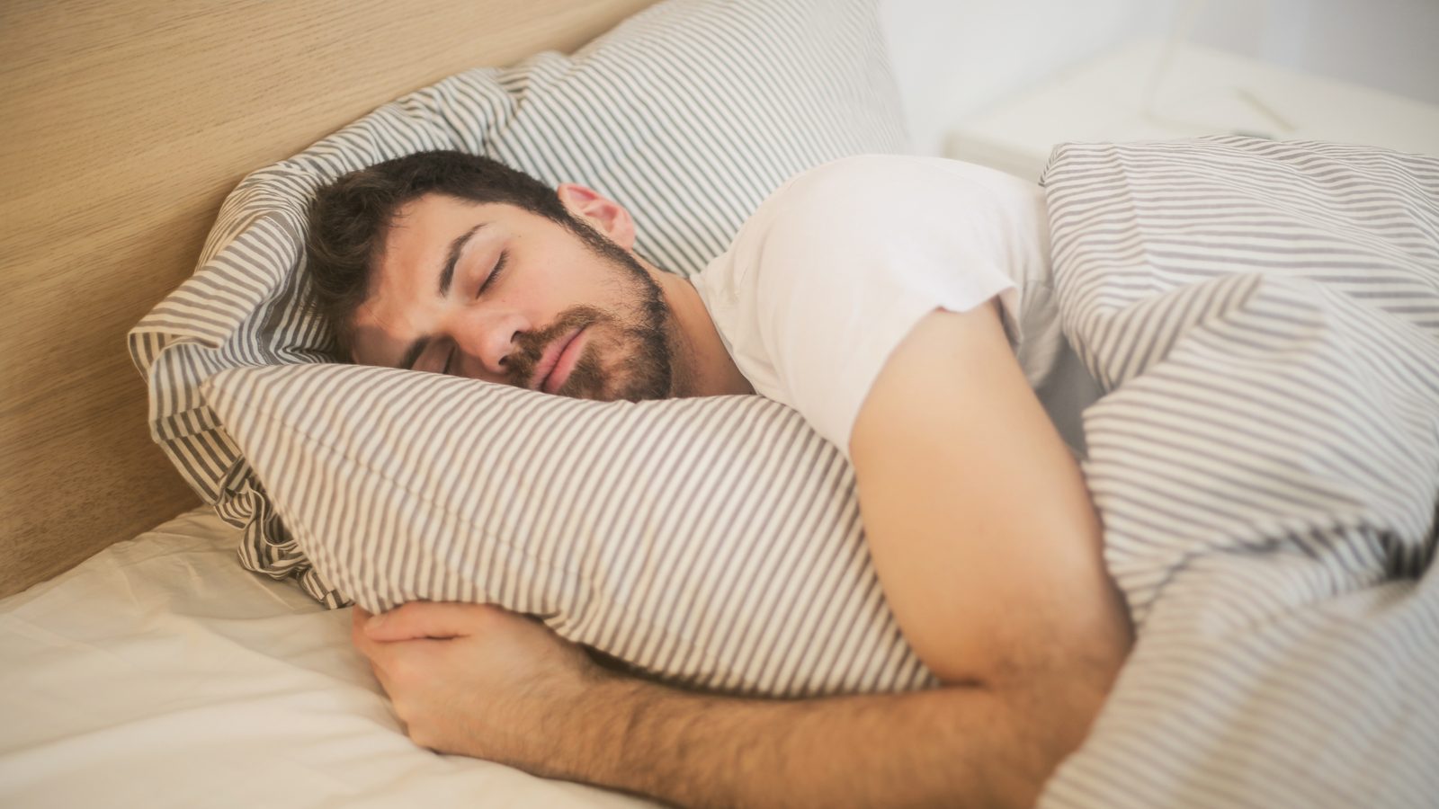 A man sleeping restfully in bed
